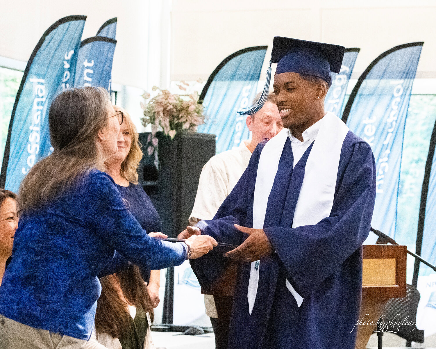 A New Market High School graduate receives his diploma.